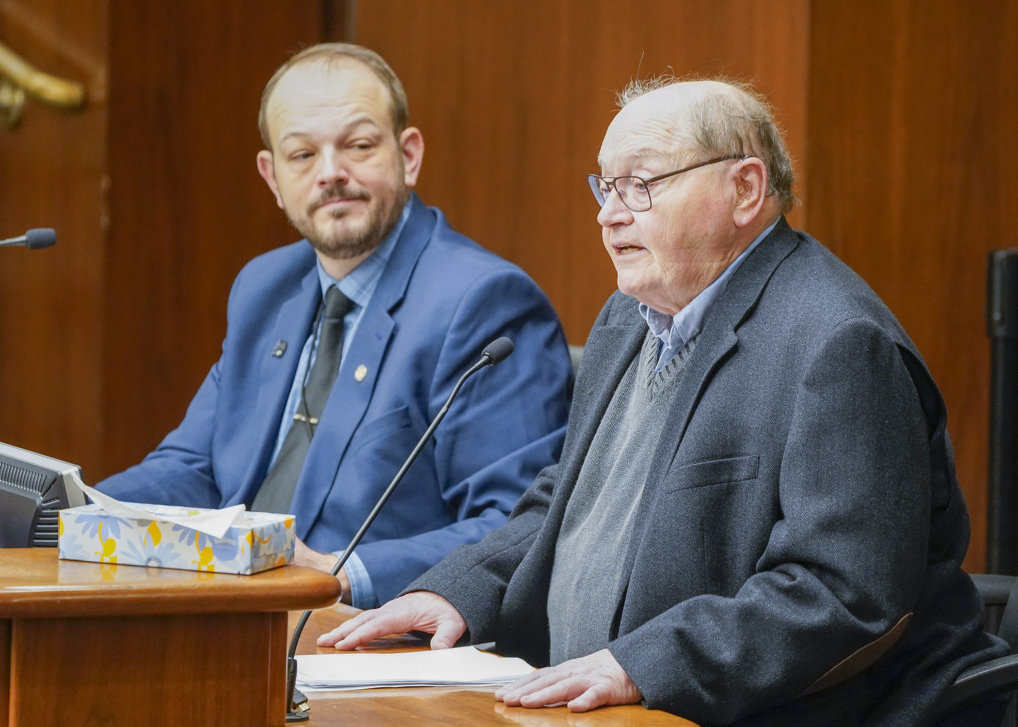 John Sherman testifies before the House Workforce Development Finance and Policy Committee March 8 in support of a bill sponsored by Rep. Jeff Brand, left, to provide rate increases for providers of extended employment services. (Photo by Andrew VonBank)